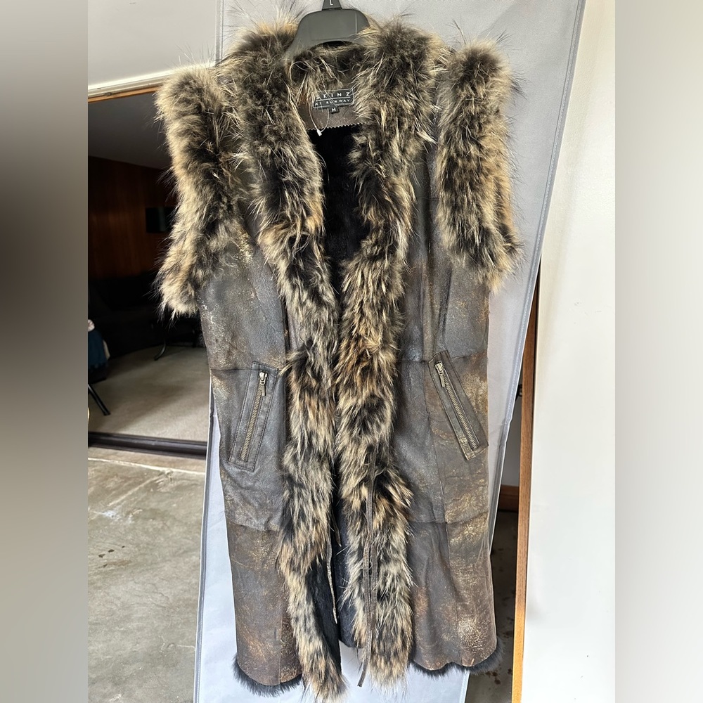 Skinz at Runway long vest with fur trim and lining. Worn once. Slight defect.